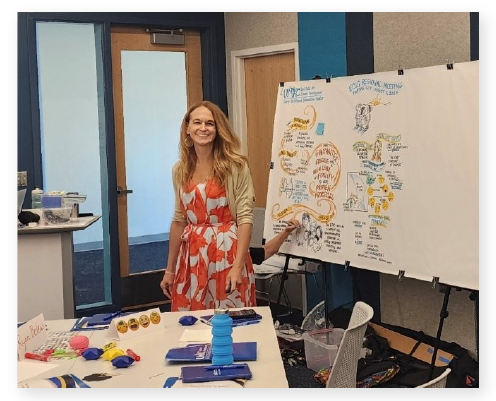 Kara Lehnhardt smiling at the camera while presenting at UMKC