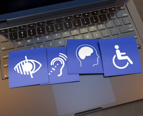 laptop with cards showing four different disabilities, visual, hearing, mental, physical