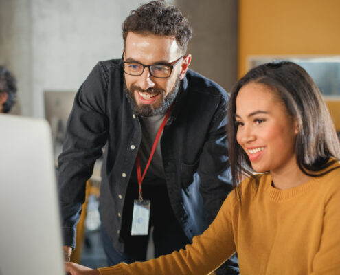 IT Helpdesk helping setting up co workers computer