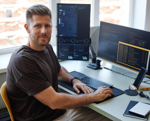 IT staff Smiling at Camera while working