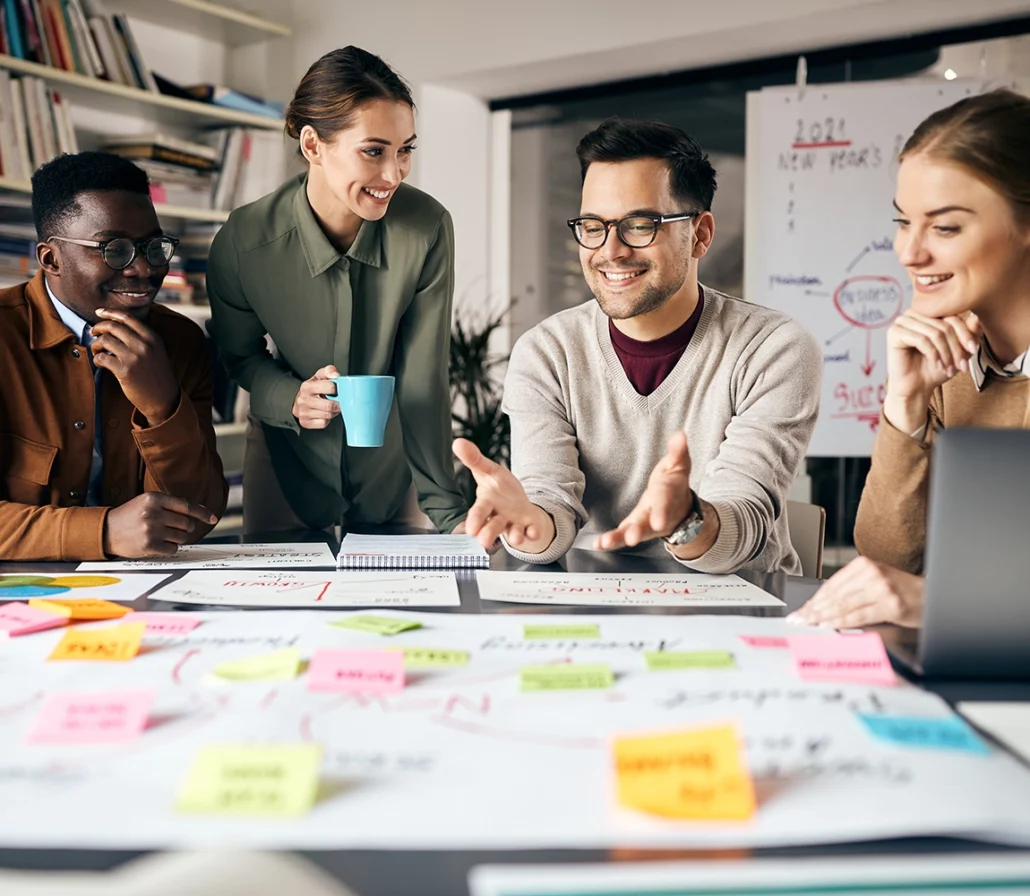 Four people working on a project around a table