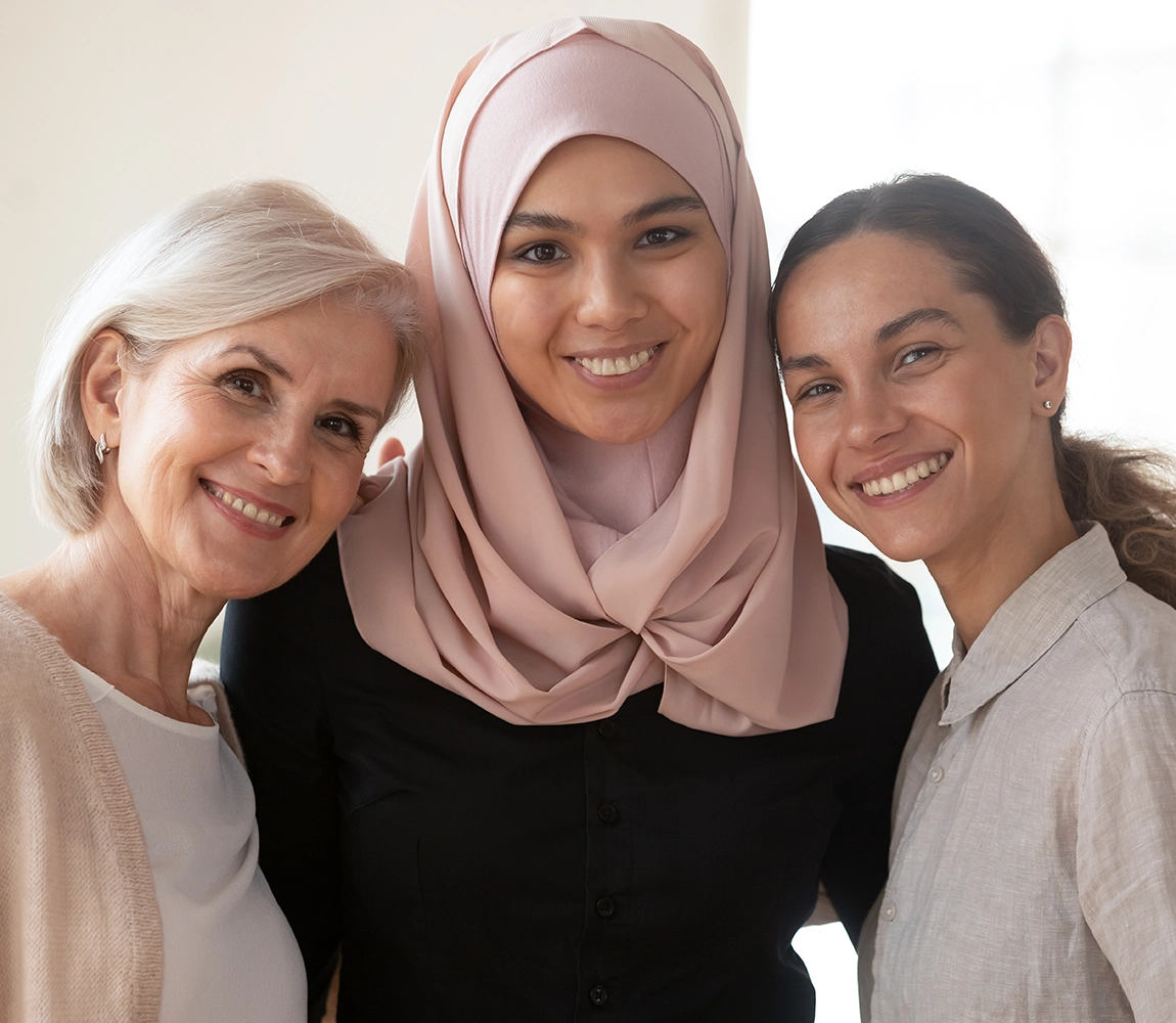 Women pose for a portrait, representing various generations.