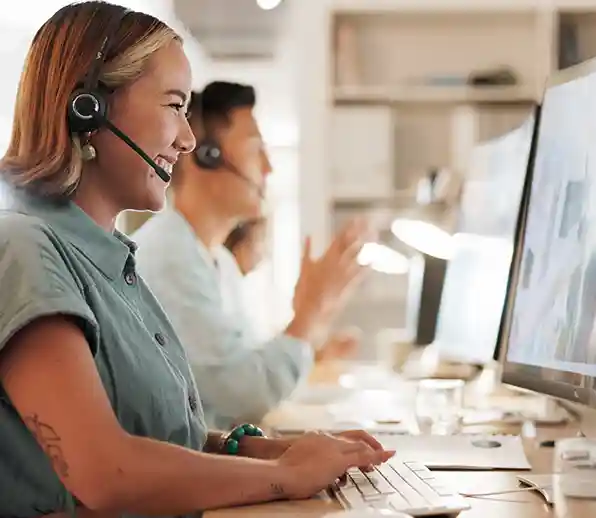 People sitting in front of a computer with a headset on