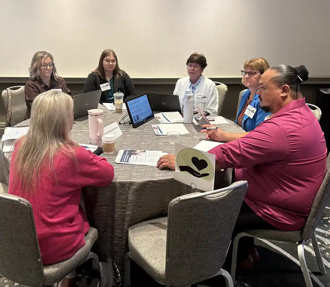 A group of people having a discussion around a table