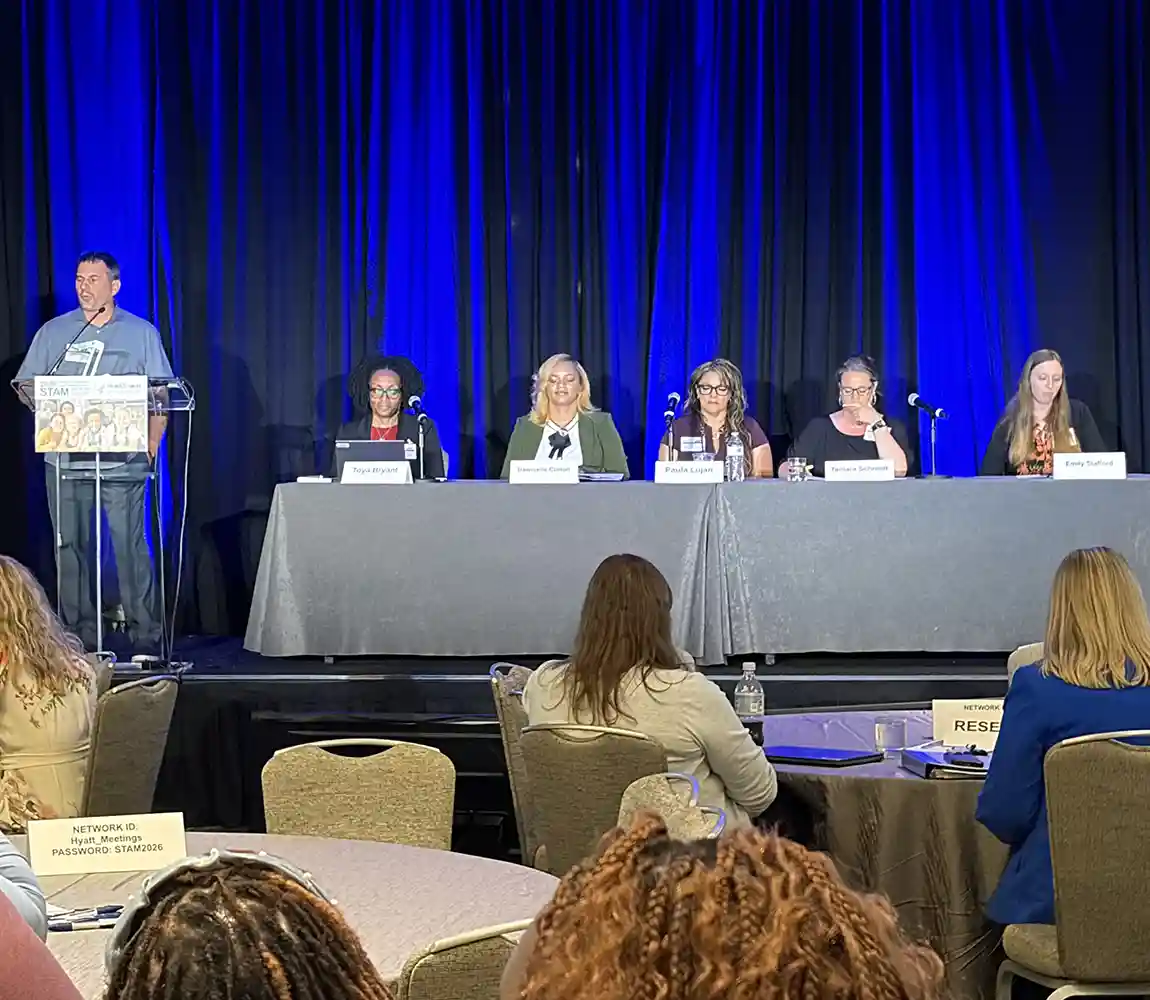 A panel of presenters on stage