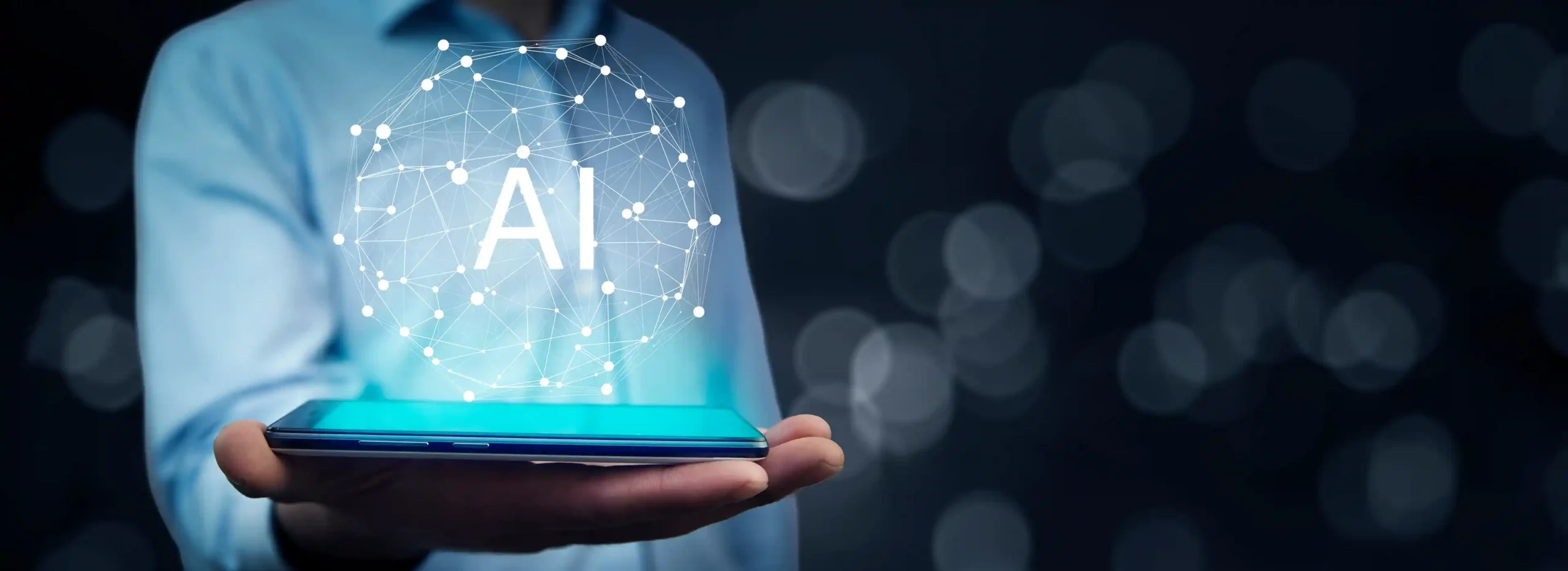 A hand holding a device with the letters AI projecting from it.